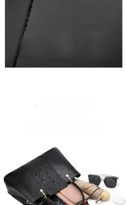 Detailed view of black leather handbag capacity with pink wallet and umbrella