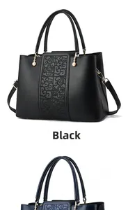Detailed embroidery of Chinese cloud patterns on a black leather handbag with gold hardware