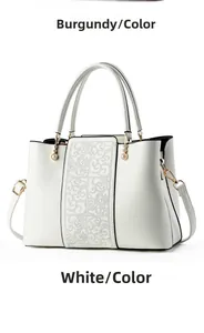 Close-up of white tote bag featuring elegant cloud embroidery and pearl zipper charm