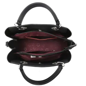 Detailed interior of black leather tote bag with red floral lining and multiple compartments