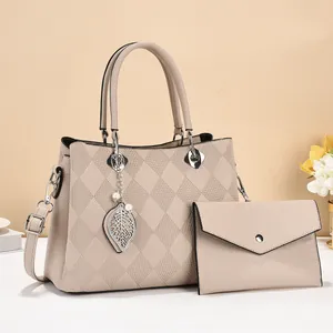 Elegant beige quilted tote bag set with leaf charm and matching envelope clutch purse