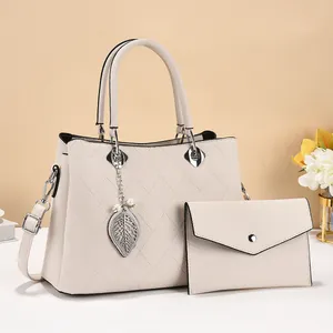 Fashionable beige quilted handbag with pearl leaf pendant and matching envelope clutch set
