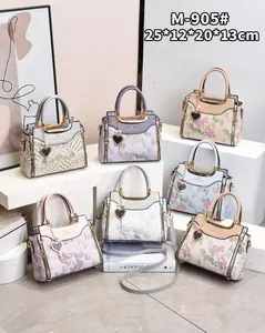 Detail shot of elegant floral embroidery and stylish metal handle on multi-color bags