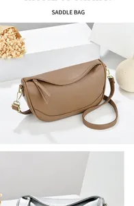 Detail of classic saddle bags in litchi leather and silver metallic finish with gold buckles