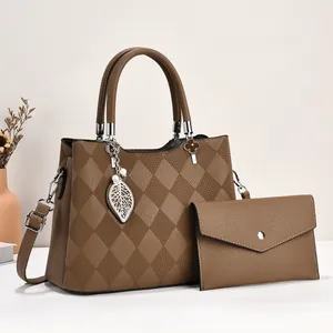 Brown quilted PU leather handbag set with leaf pendant and matching envelope clutch bag