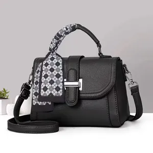 Chic black litchi pattern leather handbag with silk scarf handle and silver buckle detail