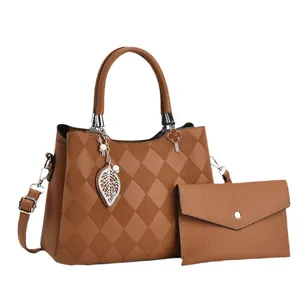 Women's quilted shoulder bag set in caramel leather with matching envelope clutch