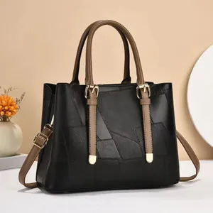 Chic black and brown patchwork leather tote bag with top handle and adjustable strap
