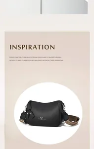 Dettaglio mini borsa a tracolla in pelle nera martellata con tracolla jacquard
