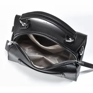 Interior view of black pebbled leather crossbody bag with multiple inner compartments