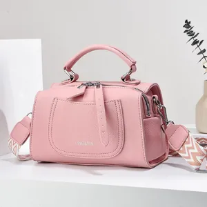 Pink lychee leather crossbody bag with geometric woven strap and silver hardware