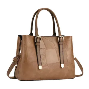 Retro brown patchwork PU leather handbag with dual handles and adjustable shoulder strap