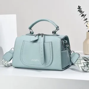 Light blue lychee pattern faux leather handbag with wide geometric fabric strap