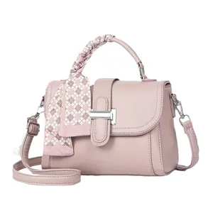 Chic pink textured faux leather crossbody bag with silk scarf handle and silver lock