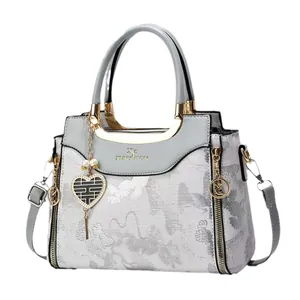 Elegant grey embroidered floral handbag with heart charm and golden metal hardware detail