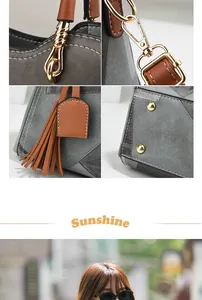 Detail view of stitched panel handbag with brown tassel and gold hardware accents