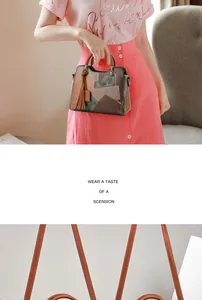 Detail of color-block tote bag featuring suede textures and stylish long tassel pendant
