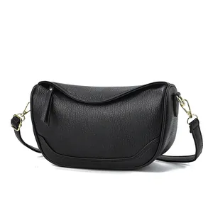 Minimalist black crescent shoulder bag with lychee texture and gold metal hardware detail