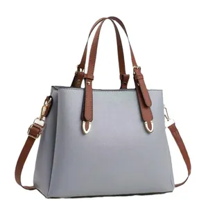 Elegant grey-blue pebbled PU leather tote bag with brown handles and gold hardware