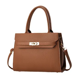 Brown lychee leather tote bag with gold hardware shown from the front on white background