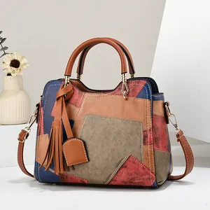 Retro patchwork handbag for women featuring multicolor panels and stylish tassel detail