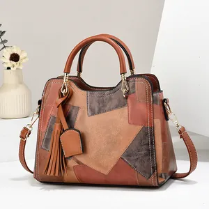 Middle-aged women's fashion handbag with patchwork leather design and tassel charm