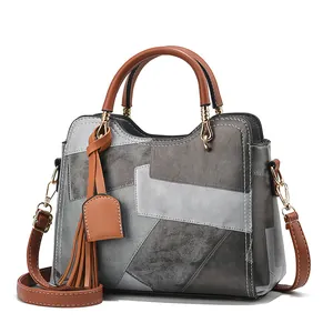 Middle-aged women's fashion handbag with gray geometric patchwork and brown leather handles