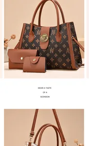 Close-up of a three-piece floral print tote set with golden lion head relief buckle