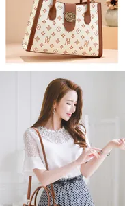 Detail of a beige tote bag featuring brown monogram print and stylish metallic clasp closure