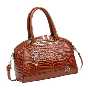 Brown crocodile-textured shoulder bag with gold K-logo and elegant heart charm