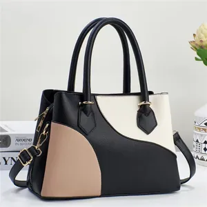 Sac à main élégant en cuir bicolore noir et beige avec bandoulière réglable pratique