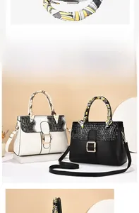Detail of high-capacity PU leather handbags with crocodile texture and silk scarf handle decor
