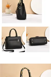 Detail view of black PU leather bag with metal feet, back zipper, and printed silk scarf