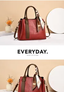 Detail view of red patchwork handbag with a patterned scarf and autumn decor