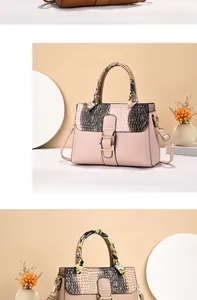 Detail of pink and khaki PU leather handbags with crocodile pattern and silk scarf handle