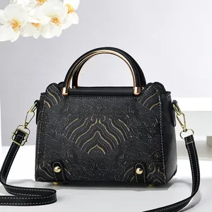 Elegant black and gold shoulder bag with classical embroidery and metal circular handle