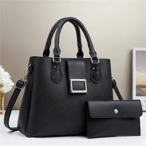 Elegant black lychee leather tote bag set with matching wallet and silver buckle accent