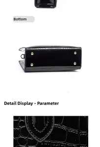 Detail view of the black crocodile pattern handbag bottom with golden protective studs