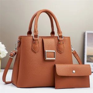 Brown textured leather handbag set with silver buckle and matching envelope pouch
