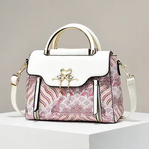 Retro hand bag with Chinese cloud embroidery and golden swan clasp on a white pedestal
