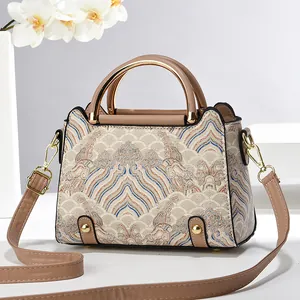 Ethnic pattern crossbody bag with blue waves and gold hardware on white background