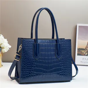 Dark blue crocodile pattern tote bag with polished finish and long handles for daily wear