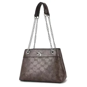 Dark brown shoulder bag with bow embossing and silver chain strap on white background
