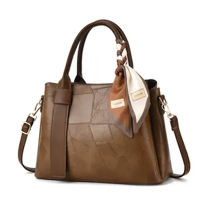 Women's stitched leather handbag in dark coffee with scarf and gold hardware accessories