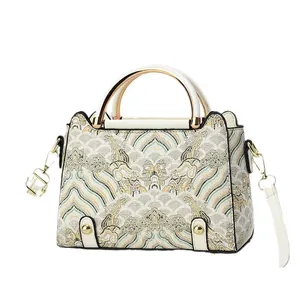 Elegant Chinese style patchwork embroidery crossbody bag with gold handle and cloud patterns