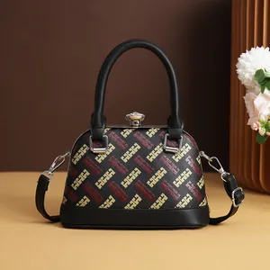 Vintage shell-shaped handbag with geometric pattern and crystal clasp on beige table