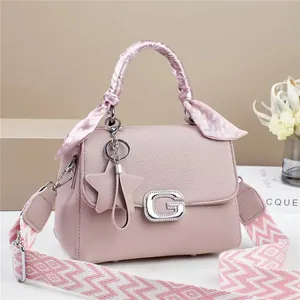 Pink lychee leather crossbody bag with G-metal buckle and floral scarf handle wrap