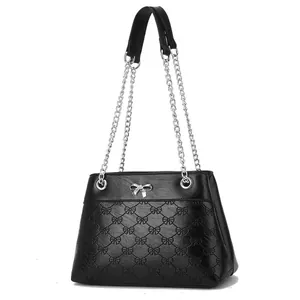 Front view of black chain bag with embossed bow patterns and silver metal buckle