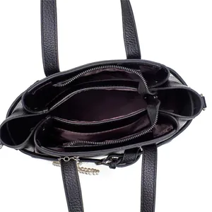 Internal view of black tote bag showing three compartments and purple lining