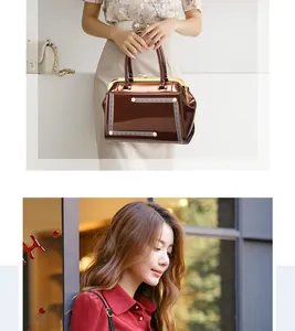 Detail of vintage brown patent leather doctor bag with gold frame and pearl accents